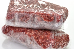 Two one-pound packages of frozen ground beef wrapped in clear plastic